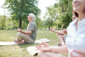 Seniors meditating in park